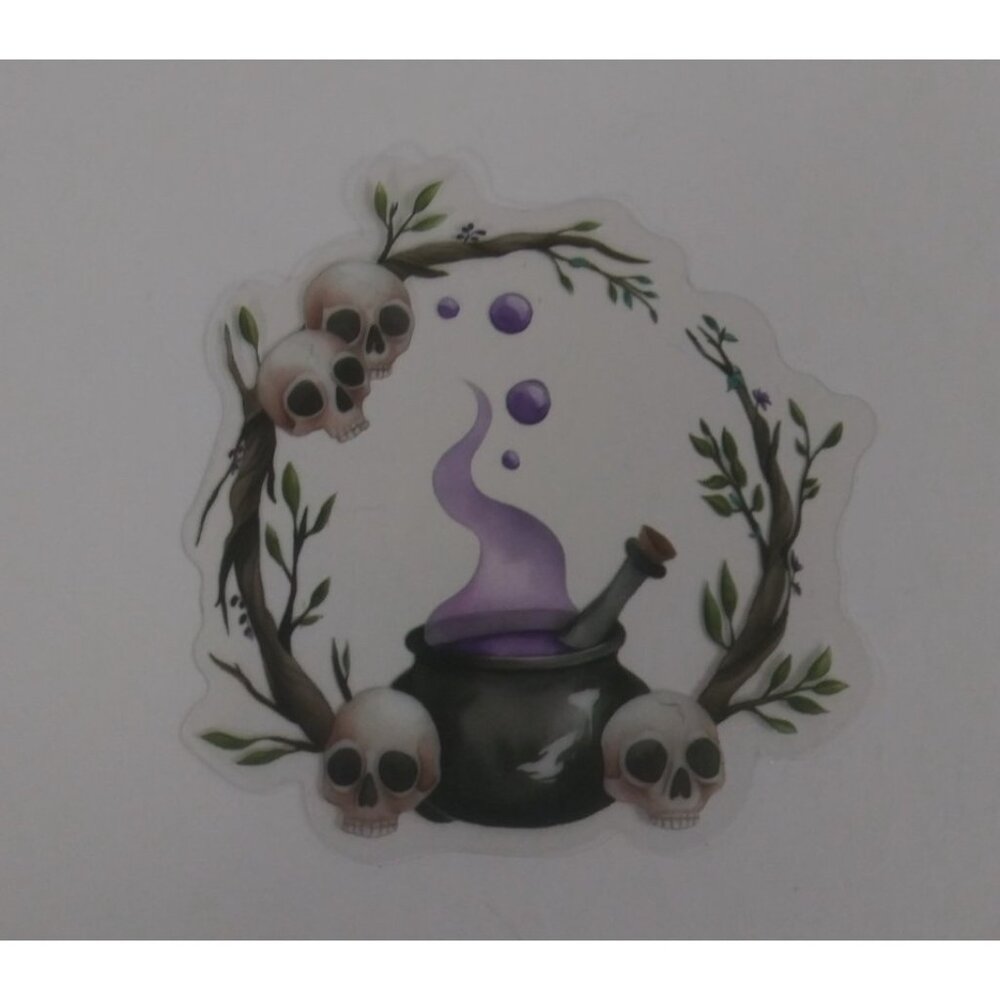 10/$10 Bubbling Cauldron With Skulls Transparent Sticker 2.18" x 2" (AW)